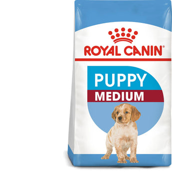 A bag of Royal Canin Medium Puppy dry dog food with a graphic of a puppy and text highlighting health nutrition and immune system support.