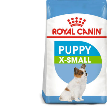 A package of Royal Canin X-Small Puppy dry dog food with a picture of a small brown and white puppy on the front. The packaging is predominantly blue with text and a badge indicating 'Health Nutrition' and 'Immune System Support'.