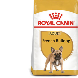 A package of Royal Canin Adult French Bulldog dry dog food with a picture of a French Bulldog on the front. The package is white with a yellow Royal Canin logo at the top and a text that highlights the breed nutrition, muscle mass condition, and tailor-made kibble.