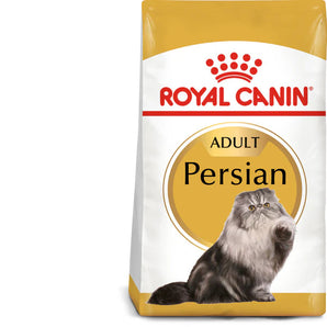 A package of Royal Canin Adult Persian dry cat food with a picture of a Persian cat on the front. The package highlights features such as 'Breed Nutrition', 'Tailor-Made Kibble', and 'Long Hair Health'.